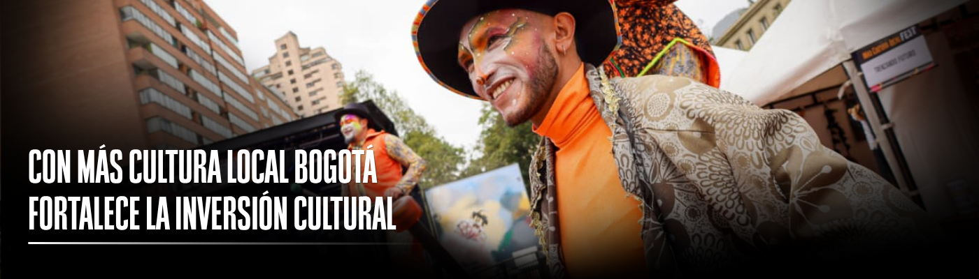 Foto de dos artistas realizando su puesta en escena en la calle, acompañado del siguiente texto: Con Más Cultura Local Bogotá fortalece la inversión cultural