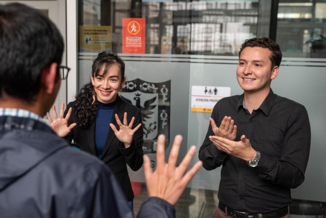 Tres personas comunicándose a partir de lenguaje de señas
